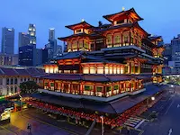 Buddha Tooth Relic Temple beautifully illuminated at night, a cultural highlight of your Singapore and Malaysia itinerary.